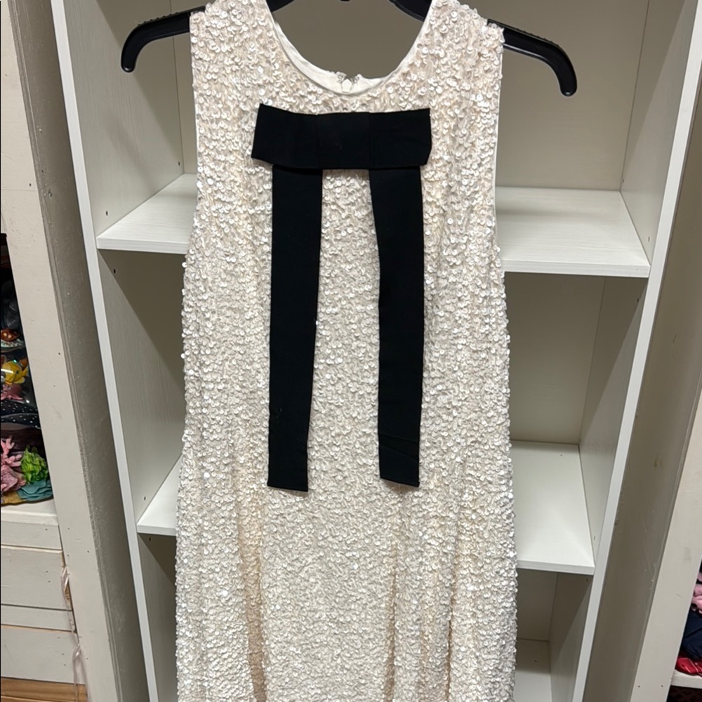 Elegant Cream Textured Mini Dress with Black Bow